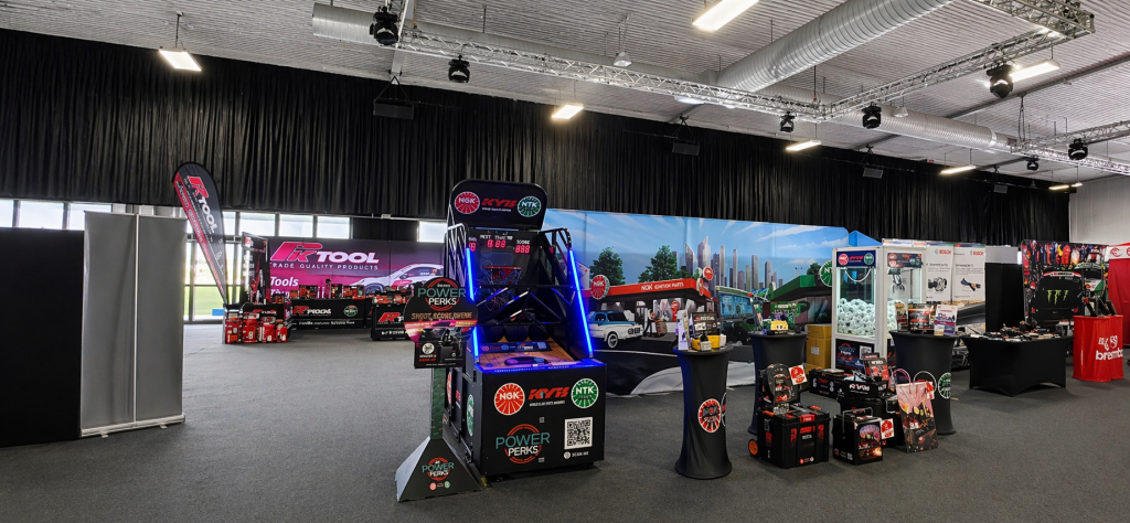 Multiple branded arcade machines on a Melbourne expo floor stand